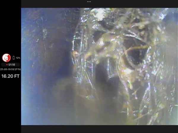 Sewer camera (borescope) footage showing heavy root intrusion inside the pipe at 16.20 feet depth.